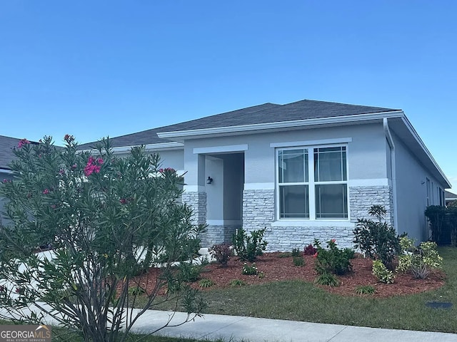 541 Buchannan Dr, Davenport, FL 33837 - view of front of property featuring stone siding and stucco siding
