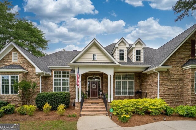1421 Jack Malcom Rd, Madison, GA 30650 - view of front of house with stone siding, roof with shingles, and covered porch