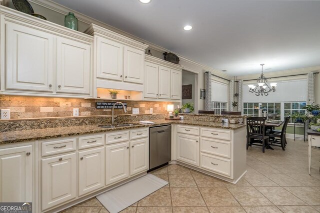 1421 Jack Malcom Rd, Madison, GA 30650 - kitchen featuring stainless steel dishwasher, a chandelier, a peninsula, backsplash, and white cabinets