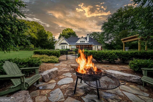 1421 Jack Malcom Rd, Madison, GA 30650 - patio terrace at dusk featuring an outdoor fire pit and a patio area