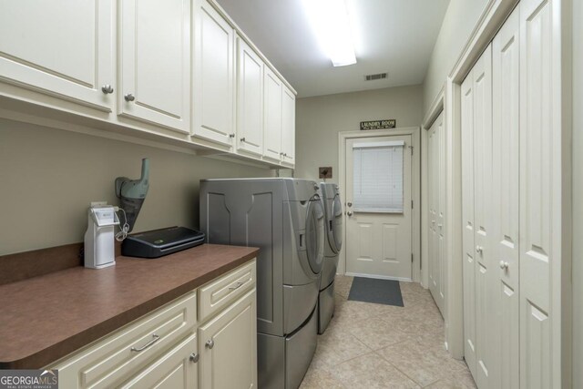 1421 Jack Malcom Rd, Madison, GA 30650 - washroom with separate washer and dryer, cabinet space, and light tile patterned floors