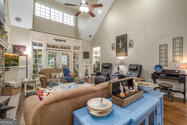 1421 Jack Malcom Rd, Madison, GA 30650 - living area featuring high vaulted ceiling, ceiling fan, french doors, wood finished floors, and a stone fireplace