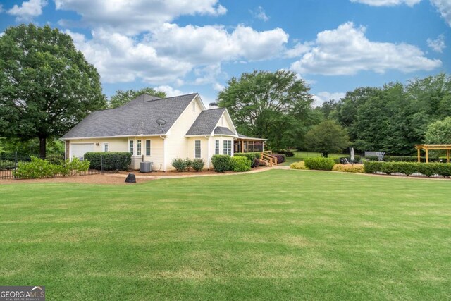 1421 Jack Malcom Rd, Madison, GA 30650 - back of house featuring an attached garage and a lawn