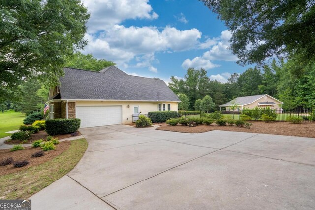 1421 Jack Malcom Rd, Madison, GA 30650 - view of side of property featuring concrete driveway, an attached garage, and a shingled roof