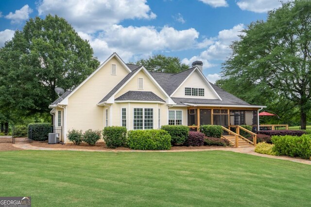 1421 Jack Malcom Rd, Madison, GA 30650 - view of front facade with a sunroom, a chimney, and a shingled roof