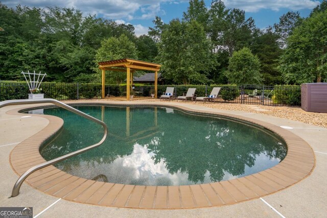 1421 Jack Malcom Rd, Madison, GA 30650 - view of swimming pool featuring a patio area and view of wooded area