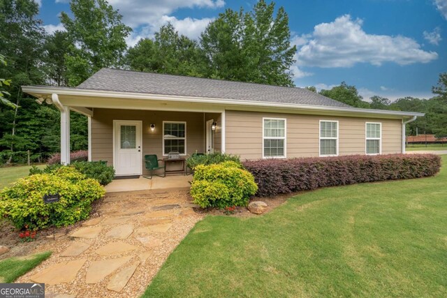 1421 Jack Malcom Rd, Madison, GA 30650 - view of front of property with a front lawn, covered porch, and a shingled roof
