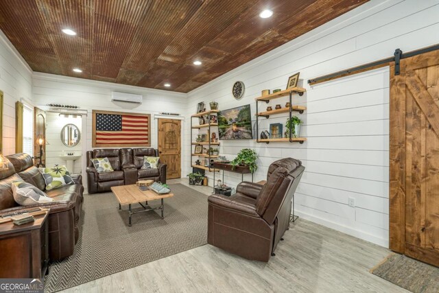 1421 Jack Malcom Rd, Madison, GA 30650 - living room featuring wood finished floors, a barn door, a wall mounted air conditioner, wood walls, and recessed lighting