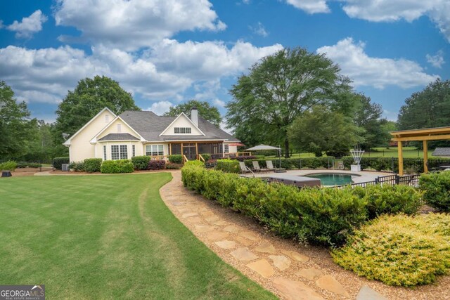 1421 Jack Malcom Rd, Madison, GA 30650 - view of front facade with a chimney, a patio area, and a sunroom