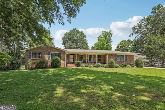 1501 Memory Ln SE, Smyrna, GA 30080 - ranch-style house with a front yard, brick siding, and covered porch