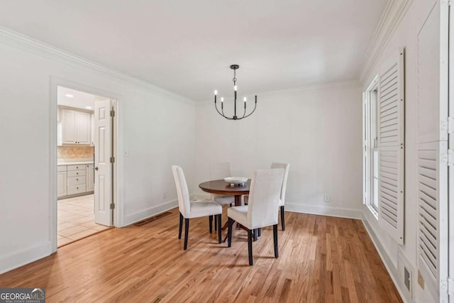 1501 Memory Ln SE, Smyrna, GA 30080 - dining area featuring a chandelier, light wood-style flooring, and crown molding