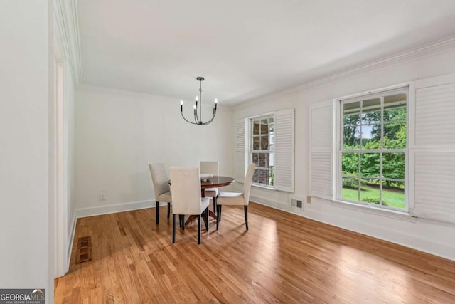 1501 Memory Ln SE, Smyrna, GA 30080 - dining area featuring crown molding, a chandelier, and light wood-type flooring