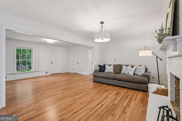 1501 Memory Ln SE, Smyrna, GA 30080 - living area featuring light wood-style flooring, crown molding, and a brick fireplace
