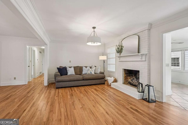 1501 Memory Ln SE, Smyrna, GA 30080 - living room with light wood-type flooring, crown molding, and a brick fireplace