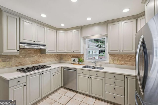 1501 Memory Ln SE, Smyrna, GA 30080 - kitchen featuring appliances with stainless steel finishes, under cabinet range hood, light countertops, decorative backsplash, and light tile patterned floors