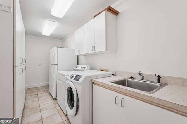 1501 Memory Ln SE, Smyrna, GA 30080 - laundry area featuring ornamental molding, light tile patterned floors, cabinet space, and separate washer and dryer