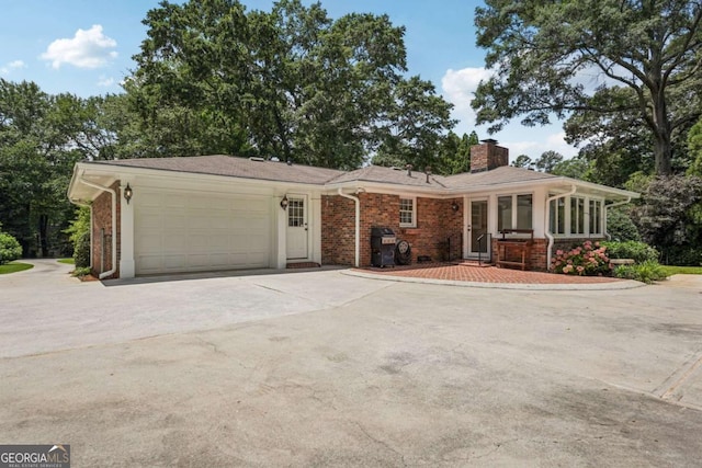 1501 Memory Ln SE, Smyrna, GA 30080 - view of front facade with a chimney, a garage, brick siding, and concrete driveway