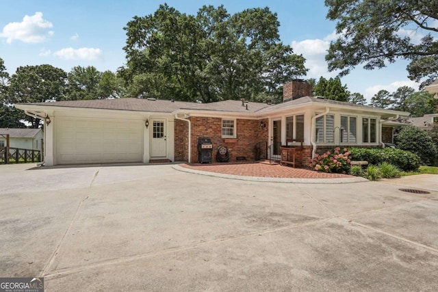 1501 Memory Ln SE, Smyrna, GA 30080 - ranch-style home with concrete driveway, a garage, a chimney, and brick siding
