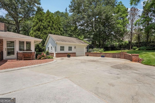 1501 Memory Ln SE, Smyrna, GA 30080 - view of side of home with an outbuilding, brick siding, concrete driveway, a chimney, and a lawn