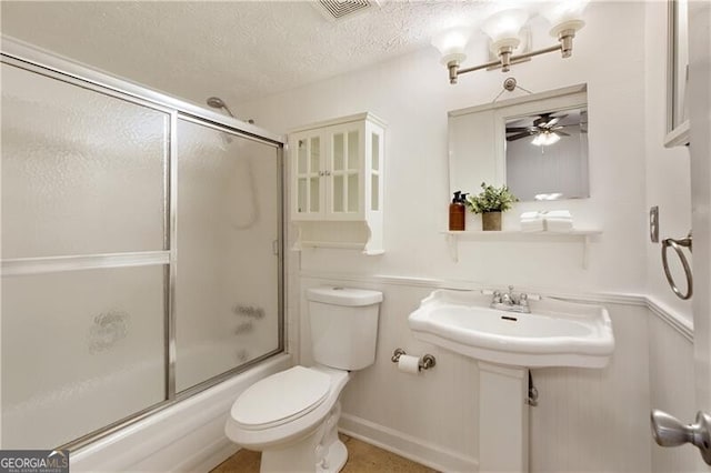 9685 Cone Ct, Roswell, GA 30075 - bathroom featuring bath / shower combo with glass door, ceiling fan, and a textured ceiling
