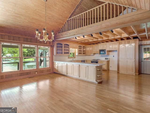 210 Roberts Point Rd, Jackson, GA 30233 - kitchen with a chandelier, glass insert cabinets, light countertops, a peninsula, and light wood-style flooring