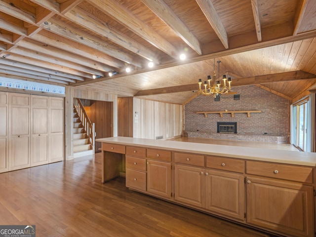 210 Roberts Point Rd, Jackson, GA 30233 - kitchen featuring a chandelier, dark wood-type flooring, light countertops, brick wall, and a brick fireplace