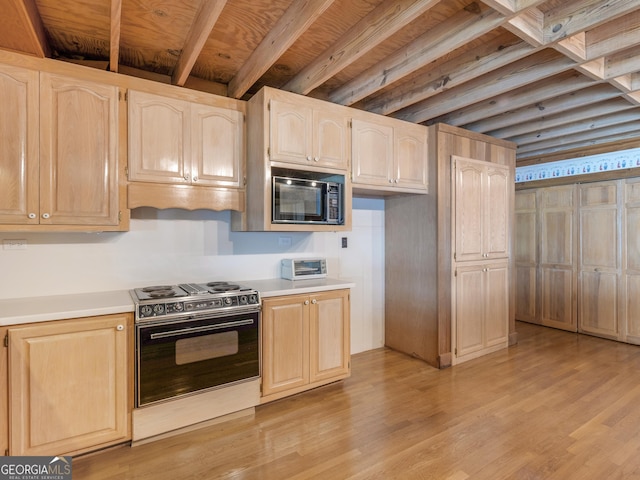 210 Roberts Point Rd, Jackson, GA 30233 - kitchen with black microwave, range with electric stovetop, light brown cabinetry, and light countertops