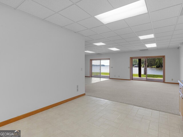 210 Roberts Point Rd, Jackson, GA 30233 - unfurnished room with light carpet, a drop ceiling, and light tile patterned floors