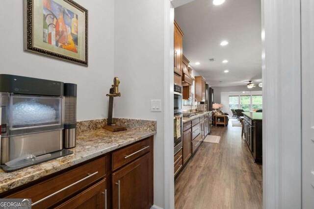7430 Ramsgate Ct, Cumming, GA 30040 - kitchen with dark wood-style floors, recessed lighting, light stone countertops, and stainless steel oven