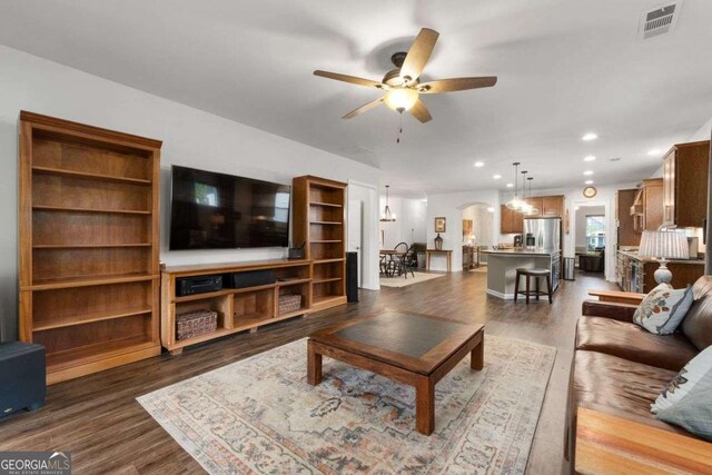 7430 Ramsgate Ct, Cumming, GA 30040 - living area featuring a ceiling fan, dark wood finished floors, recessed lighting, and arched walkways