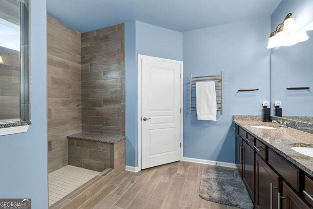 7430 Ramsgate Ct, Cumming, GA 30040 - full bath with wood finished floors, double vanity, and a tile shower
