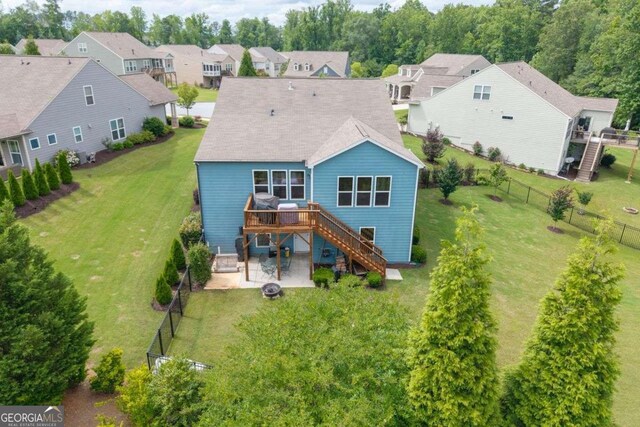 7430 Ramsgate Ct, Cumming, GA 30040 - back of property featuring stairway, a deck, a fire pit, a patio area, and a residential view