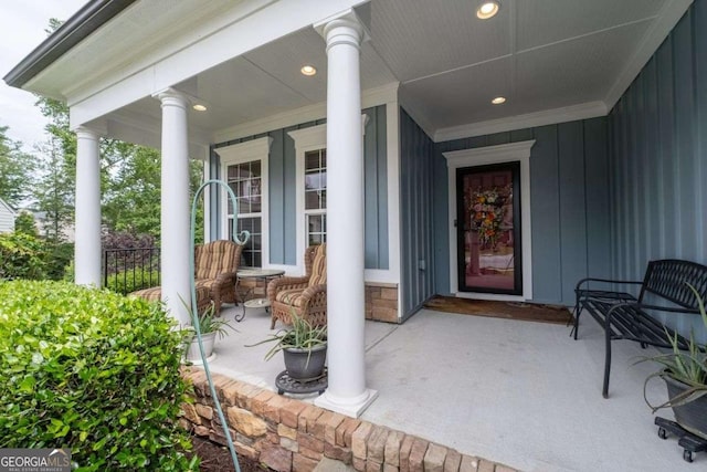 7430 Ramsgate Ct, Cumming, GA 30040 - doorway to property with covered porch and board and batten siding