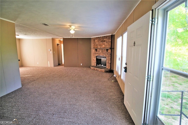 447 Smith Rd, Defuniak Springs, FL 32433 - unfurnished living room with a ceiling fan, carpet, and a brick fireplace