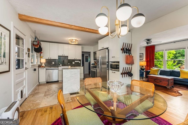 2468 Fallview Ter, Atlanta, GA 30344 - dining area with light wood-style floors, beam ceiling, and a ceiling fan
