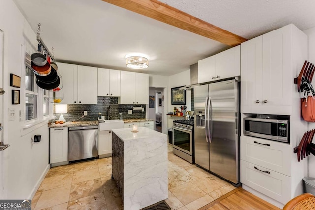 2468 Fallview Ter, Atlanta, GA 30344 - kitchen featuring appliances with stainless steel finishes, tasteful backsplash, white cabinetry, and light stone countertops