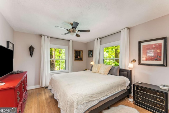 2468 Fallview Ter, Atlanta, GA 30344 - bedroom with multiple windows, wood finished floors, and ceiling fan