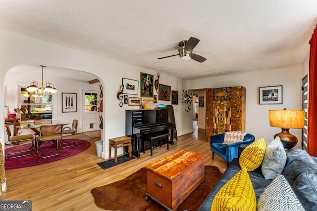 2468 Fallview Ter, Atlanta, GA 30344 - living room featuring arched walkways, wood finished floors, ceiling fan, a chandelier, and a textured ceiling