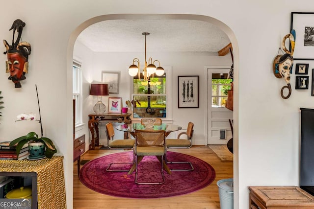 2468 Fallview Ter, Atlanta, GA 30344 - dining area featuring arched walkways, wood finished floors, and a chandelier