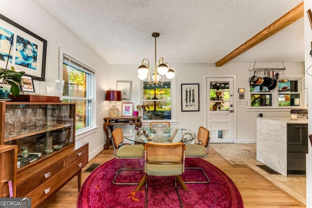 2468 Fallview Ter, Atlanta, GA 30344 - dining room featuring a textured ceiling, a chandelier, and wood finished floors