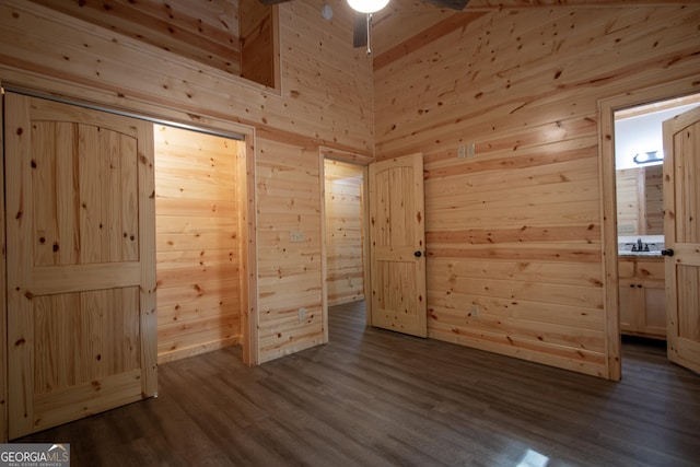 155 Stonecrest Ln, Murphy, NC 28906 - unfurnished bedroom featuring wooden walls, dark wood finished floors, and connected bathroom