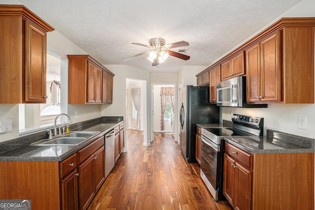40 Browning Dr, Covington, GA 30016 - kitchen with stainless steel appliances, dark countertops, ceiling fan, dark wood-type flooring, and plenty of natural light