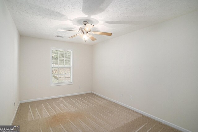40 Browning Dr, Covington, GA 30016 - spare room featuring a ceiling fan, light carpet, and a textured ceiling