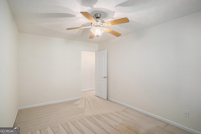40 Browning Dr, Covington, GA 30016 - spare room with light colored carpet, a ceiling fan, and a textured ceiling
