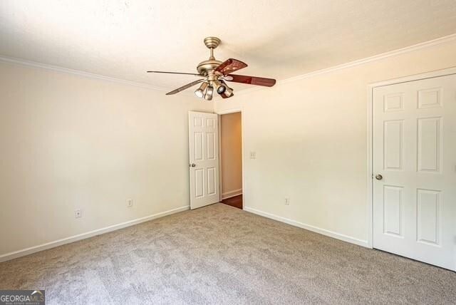 118 High Ridge Ln, Dahlonega, GA 30533 - spare room featuring a ceiling fan, carpet floors, and crown molding