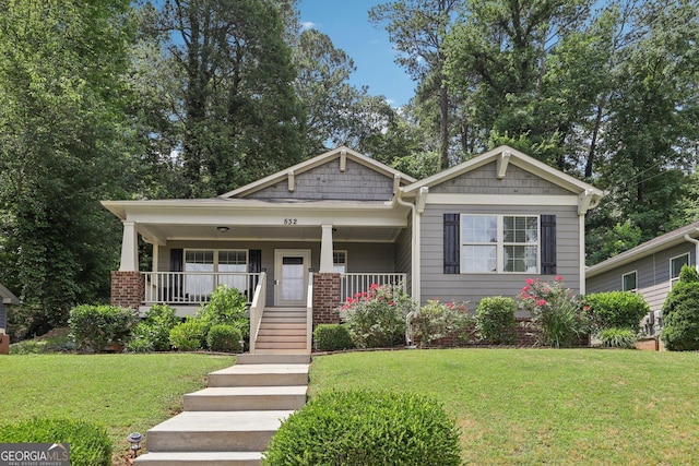 532 Lemon St NE, Marietta, GA 30060 - view of front facade with a front yard, covered porch, stairs, and brick siding