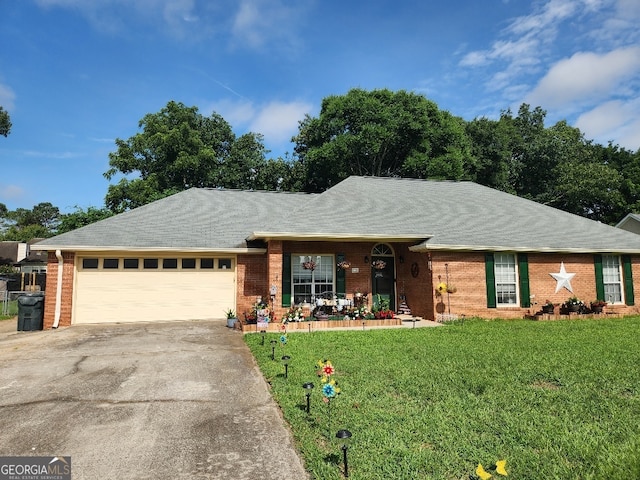115 Settlers Trl, Warner Robins, GA 31088 - ranch-style home with brick siding, driveway, a front yard, and an attached garage