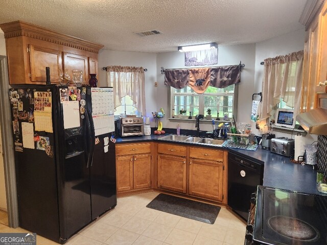 115 Settlers Trl, Warner Robins, GA 31088 - kitchen featuring black appliances, brown cabinets, dark countertops, a textured ceiling, and light tile patterned floors