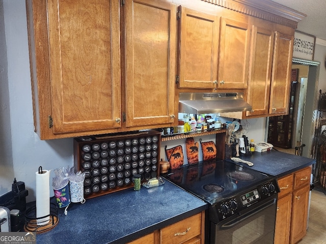 115 Settlers Trl, Warner Robins, GA 31088 - kitchen with under cabinet range hood, electric range, dark countertops, and brown cabinetry