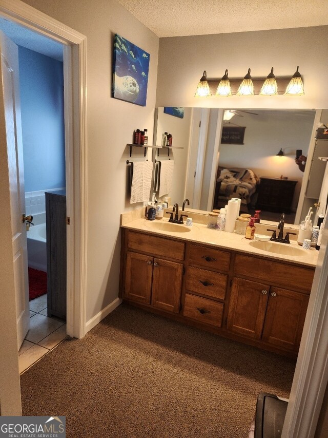 115 Settlers Trl, Warner Robins, GA 31088 - full bathroom featuring carpet, double vanity, a bath, tile patterned floors, and a textured ceiling